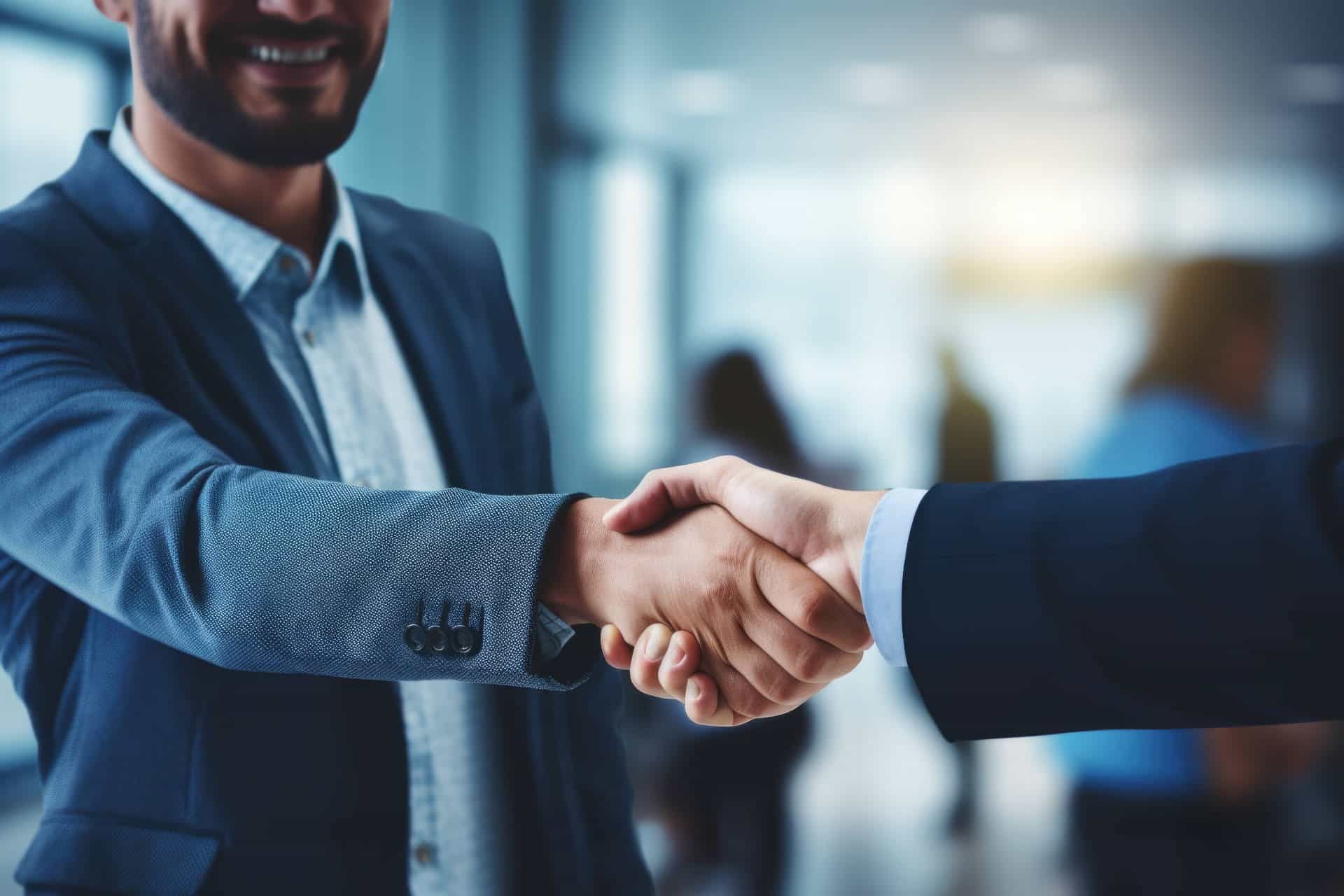 lose-up image of two people shaking hands. Professional agreement or friendly greeting. It can be used to represent business partnerships, teamwork, trust, or networking opportunities.